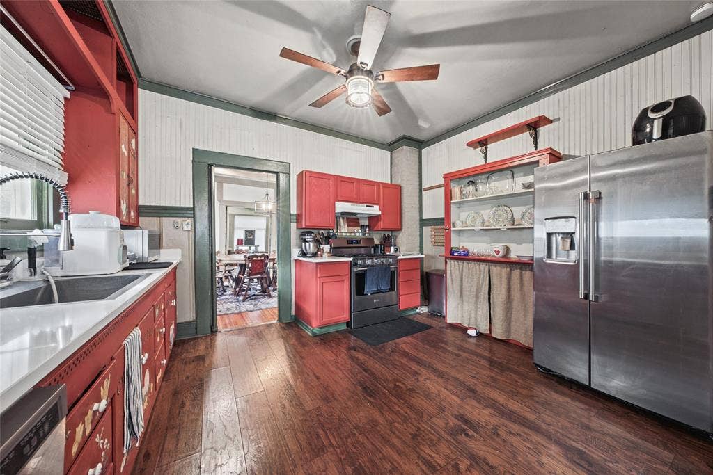 406 Summit Street, Farmersville, TX 75442 Kitchen featuring wood-finish flooring, beadboard wall paneling, stainless steel refrigerator, built-in display shelving, and ceiling-mounted light fixture