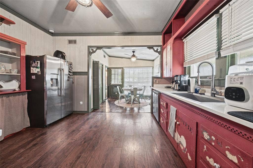 406 Summit Street, Farmersville, TX 75442 Kitchen featuring wood-finish flooring, stainless steel refrigerator, white countertops, dual-basin sink, and built-in cabinetry