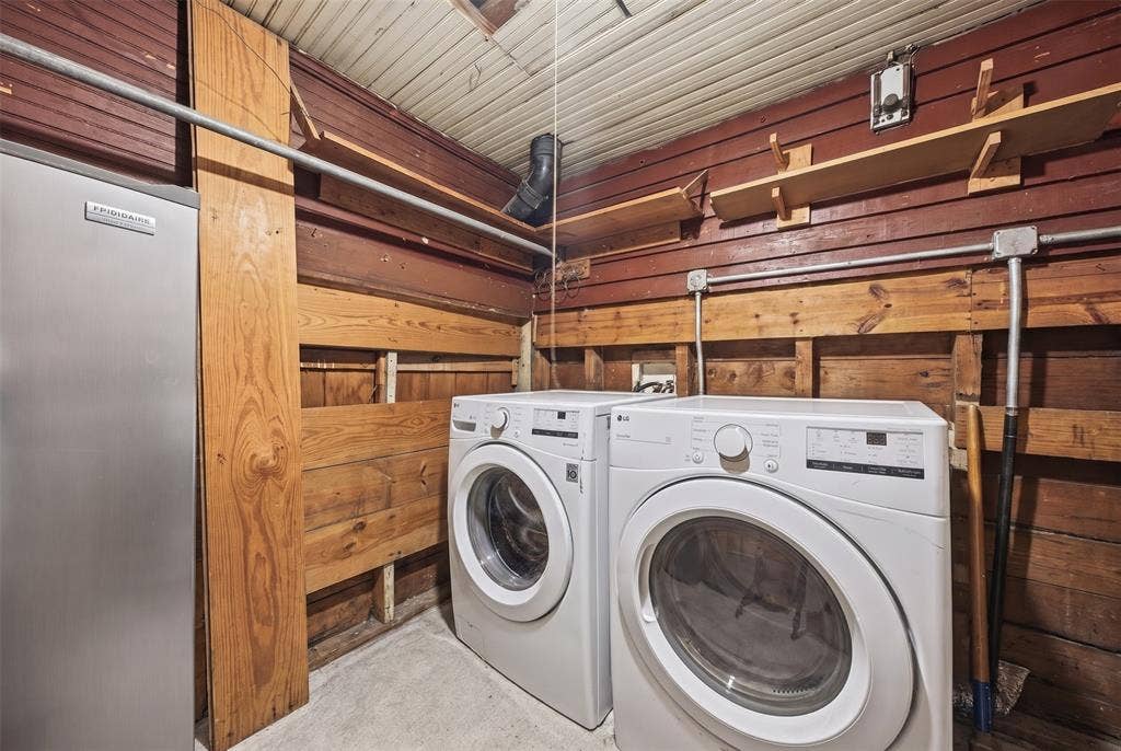 406 Summit Street, Farmersville, TX 75442 Laundry space featuring exposed wood-plank walls, built-in wooden shelving, and corrugated metal ceiling paneling