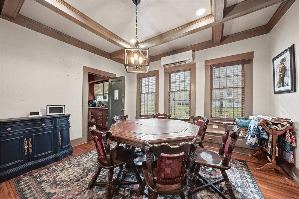 406 Summit Street, Farmersville, TX 75442 Coffered ceiling with integrated recessed lighting, decorative hanging lantern fixture, multi-pane windows with built-in bench seating, and wood-finish flooring