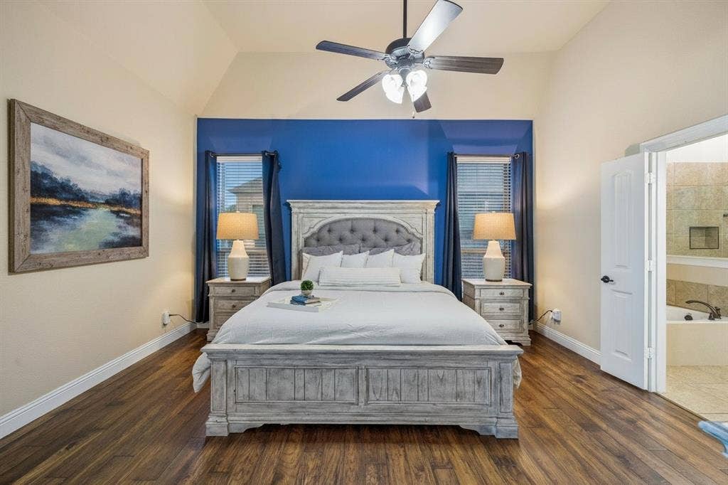 3702 Harlan Drive, Sachse, TX 75048 First-floor primary bedroom features wood flooring, generous proportions, updated lighting and an ensuite bath.