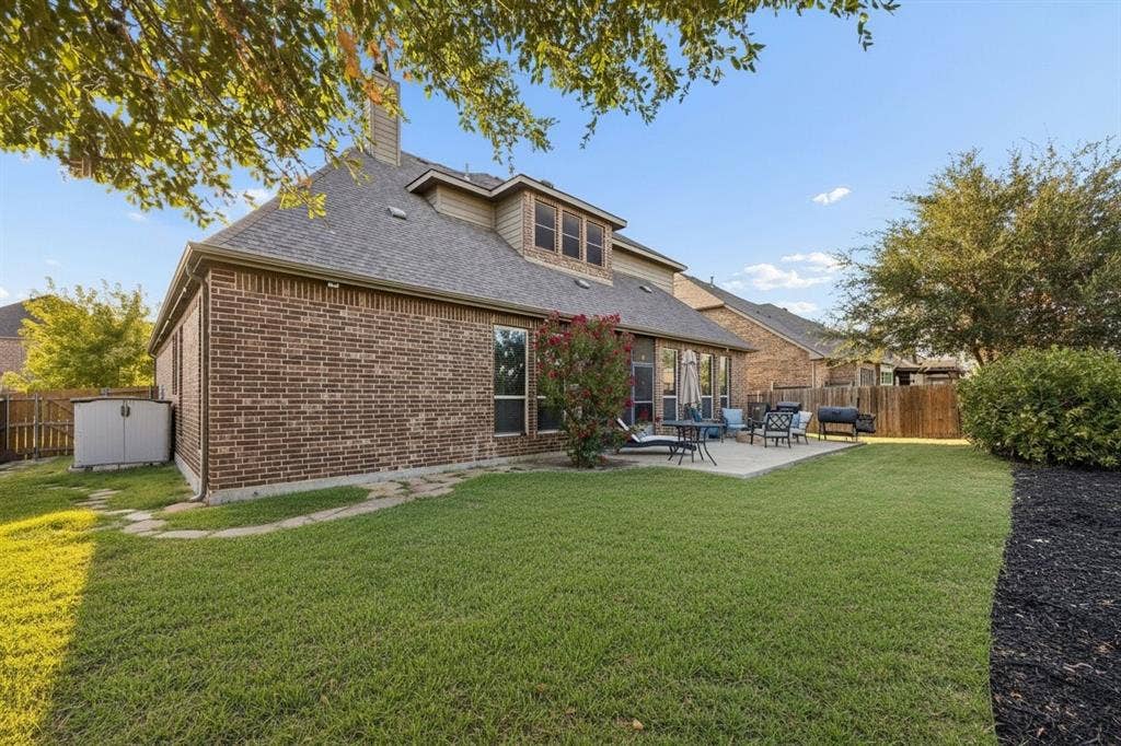 3702 Harlan Drive, Sachse, TX 75048 Backyard backs to a greenbelt with wrought iron rear fencing, creating an open backdrop with no immediate rear neighbor.
