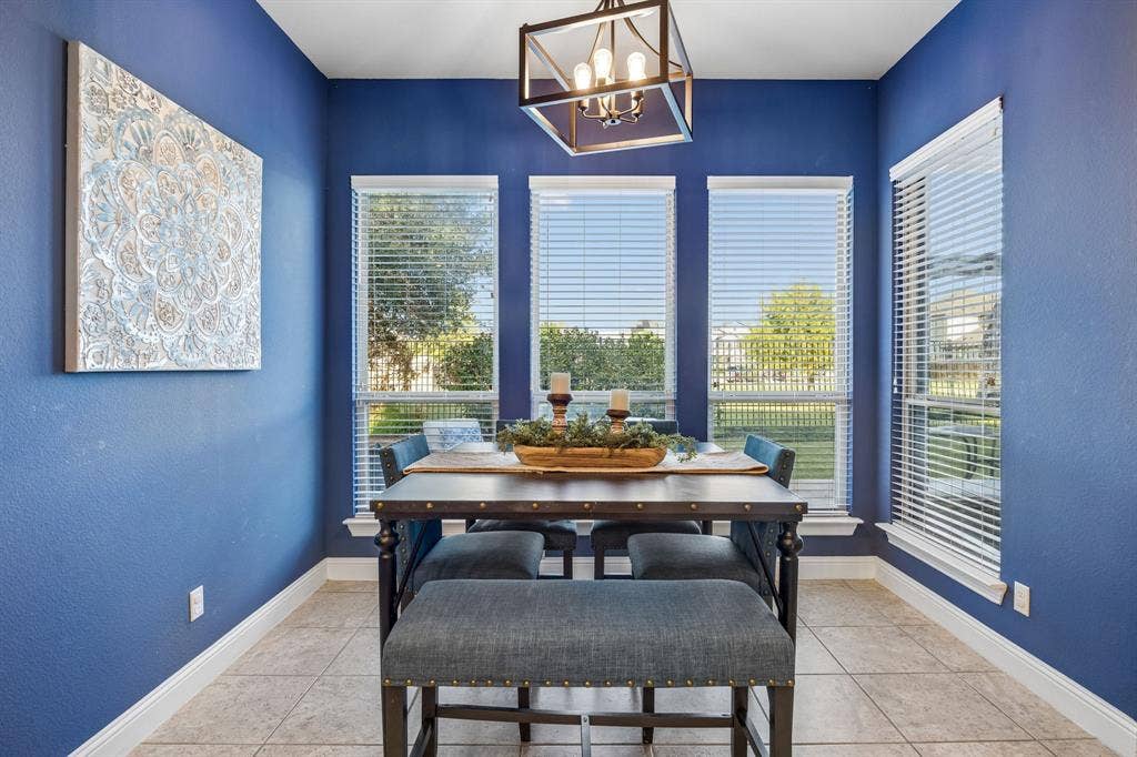 3702 Harlan Drive, Sachse, TX 75048 Light-filled breakfast area offers greenbelt views and a colorful accent wall for added character.