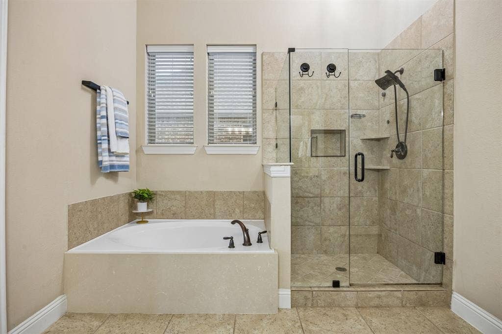 3702 Harlan Drive, Sachse, TX 75048 Primary bath combines a soaking tub, separate frameless glass shower and dual-sink vanity.