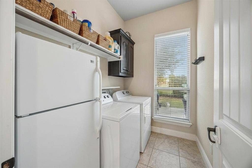3702 Harlan Drive, Sachse, TX 75048 Separate utility room provides dedicated laundry space with built-in cabinetry and room for additional storage.