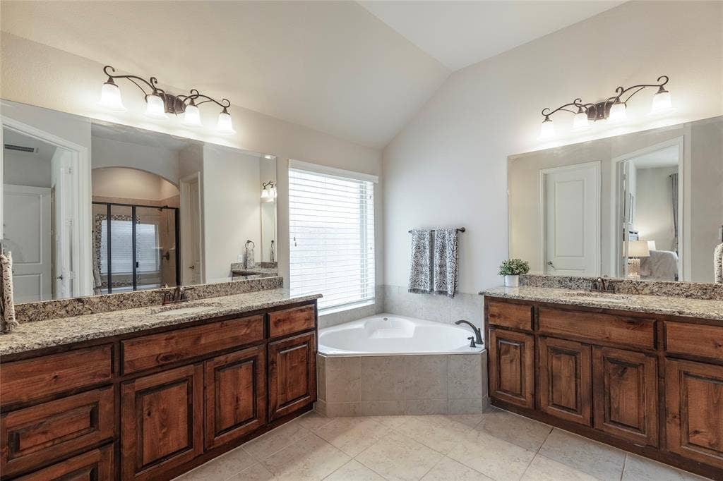 Primary bathroom with double vanities and garden tub