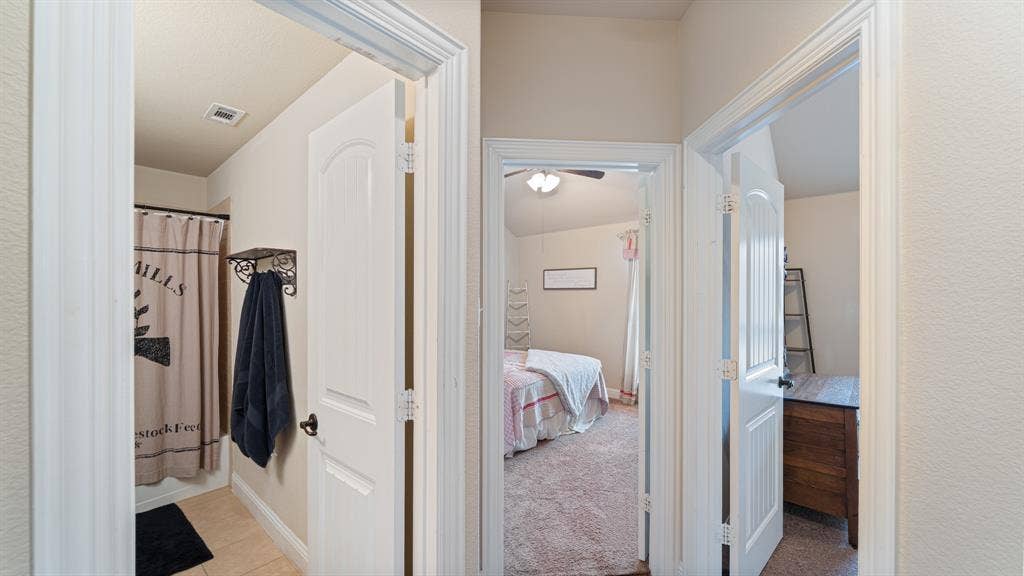 1802 Watermark Lane, Wylie, TX 75098 Hallway featuring three-panel arched interior doors, white door casing, and neutral wall tones