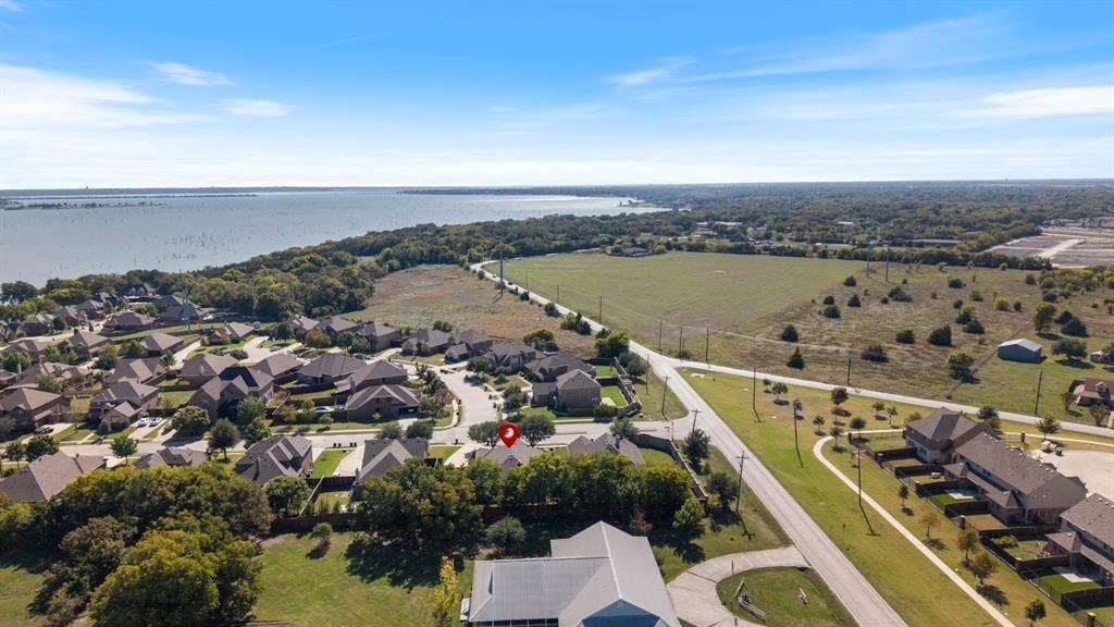 1802 Watermark Lane, Wylie, TX 75098 Aerial perspective featuring proximity to a large body of water, extensive open green space, and mature tree canopy