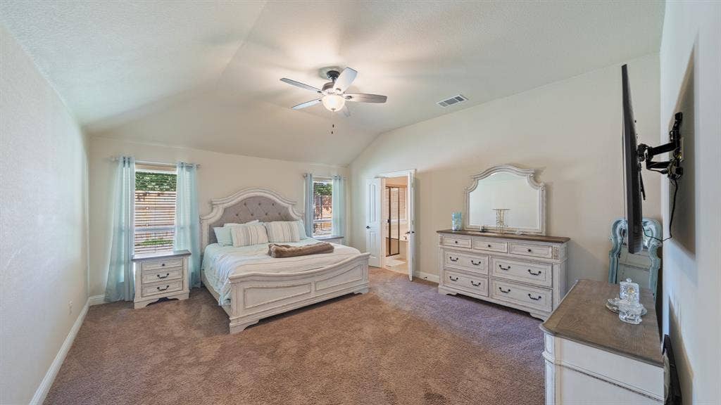 1802 Watermark Lane, Wylie, TX 75098 Vaulted ceiling with a central integrated light fixture and ceiling fan