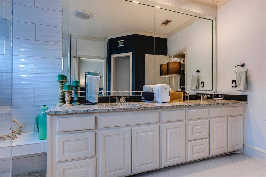 Dual vanity with a stone countertop and integrated sinks