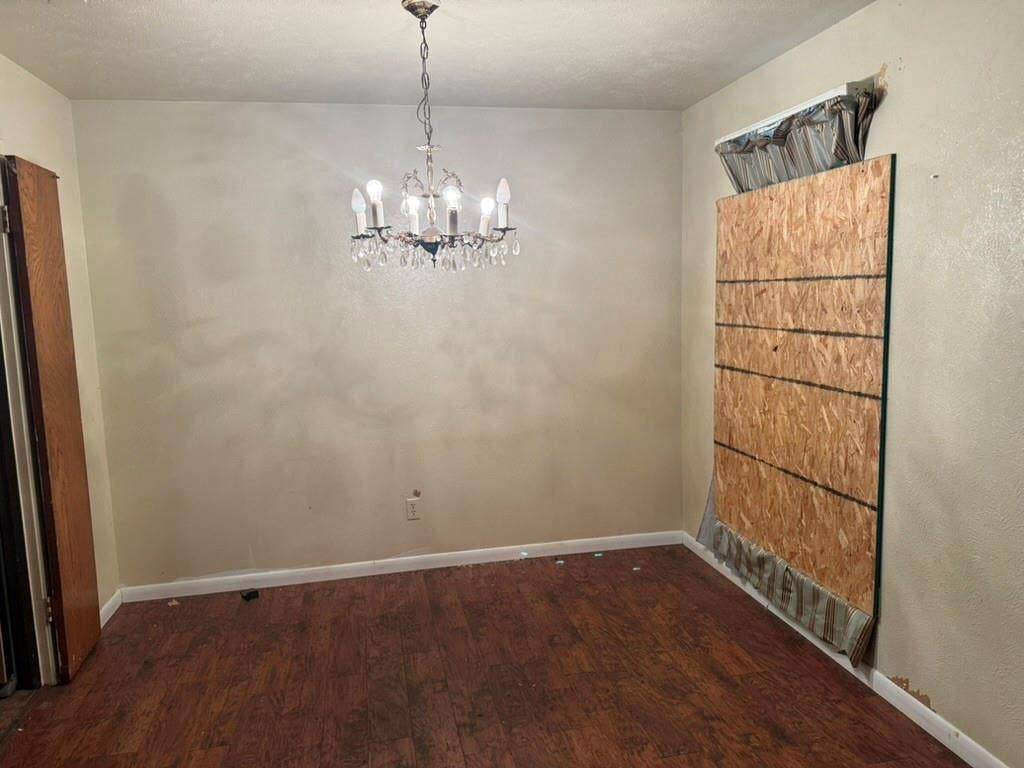 Interior space featuring wood-finish flooring and a multi-arm crystal chandelier