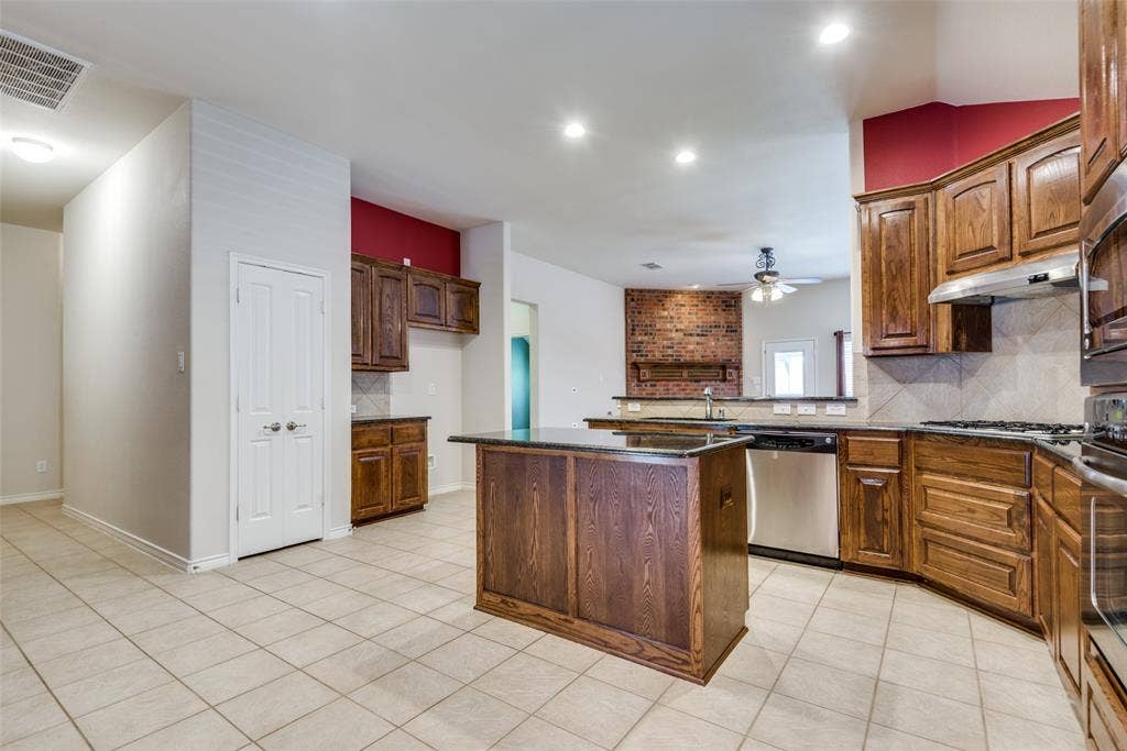 Kitchen featuring a ceiling fan, visible vents, appliances with stainless steel finishes, light tile patterned flooring, and a sink