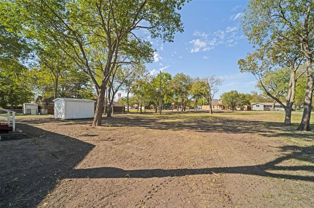 415 S Bell Street, Royse City, TX 75189 Expansive lot featuring mature trees and a detached storage shed