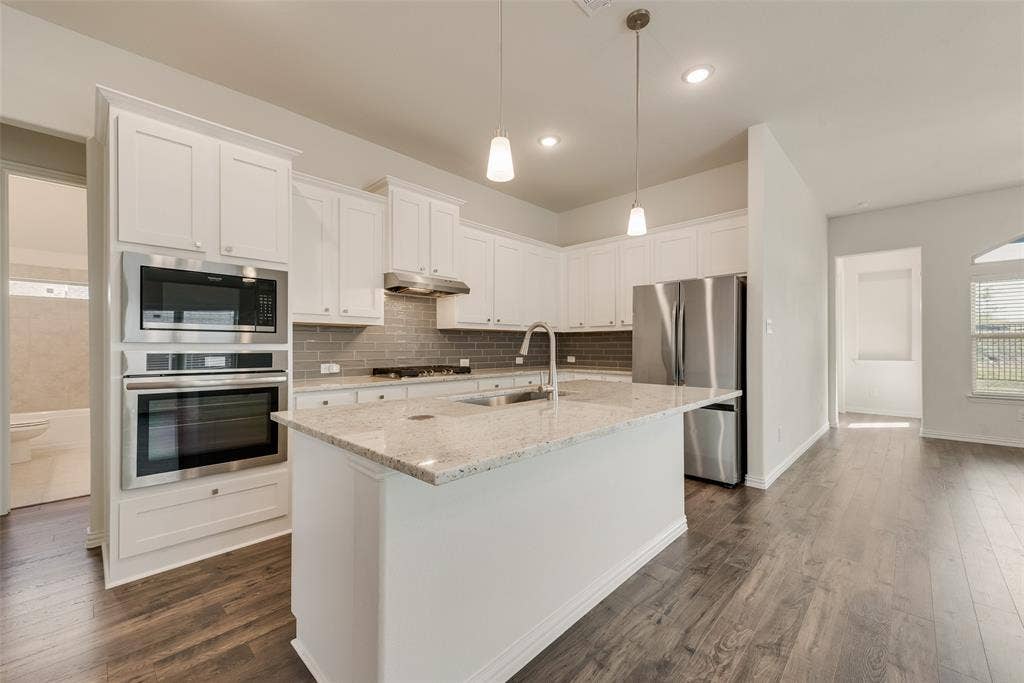 3934 Timberview Street, Midlothian, TX 76065 Kitchen featuring white cabinetry, stone countertops, stainless steel wall ovens, a tile backsplash, and wood-finish flooring