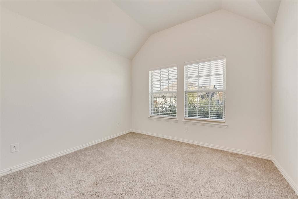 3934 Timberview Street, Midlothian, TX 76065 Interior space featuring vaulted ceilings, neutral wall tones, plush wall-to-wall carpeting, and double windows with integrated blinds