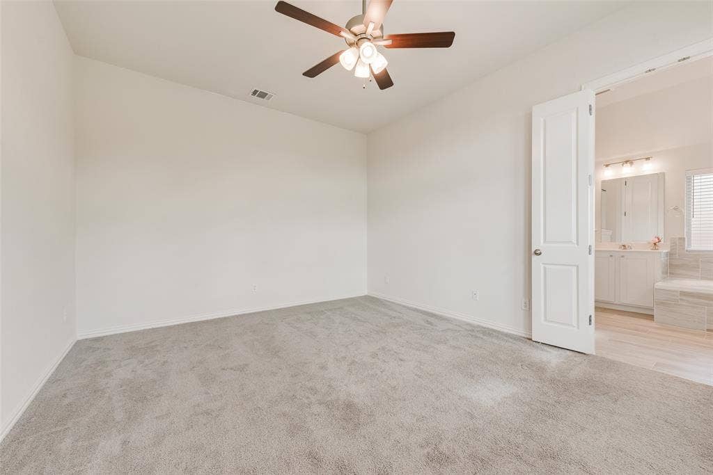 3934 Timberview Street, Midlothian, TX 76065 Neutral-toned carpeting, ceiling fan with integrated lighting, and white six-panel door