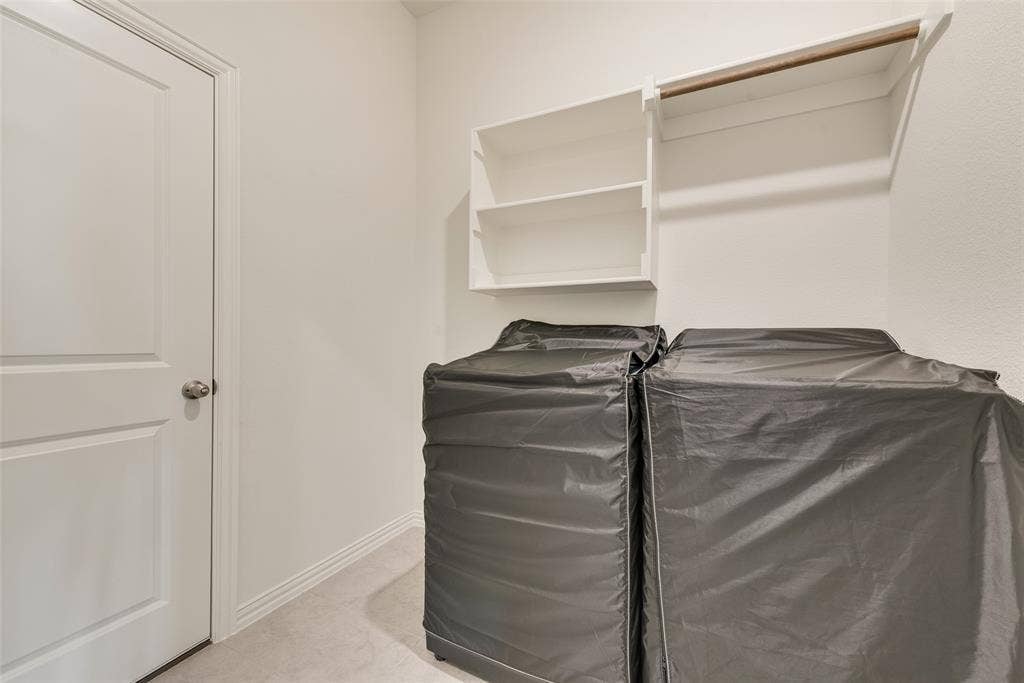3934 Timberview Street, Midlothian, TX 76065 Utility room featuring wall-mounted open shelving, a built-in hanging rod, and a solid-core interior door