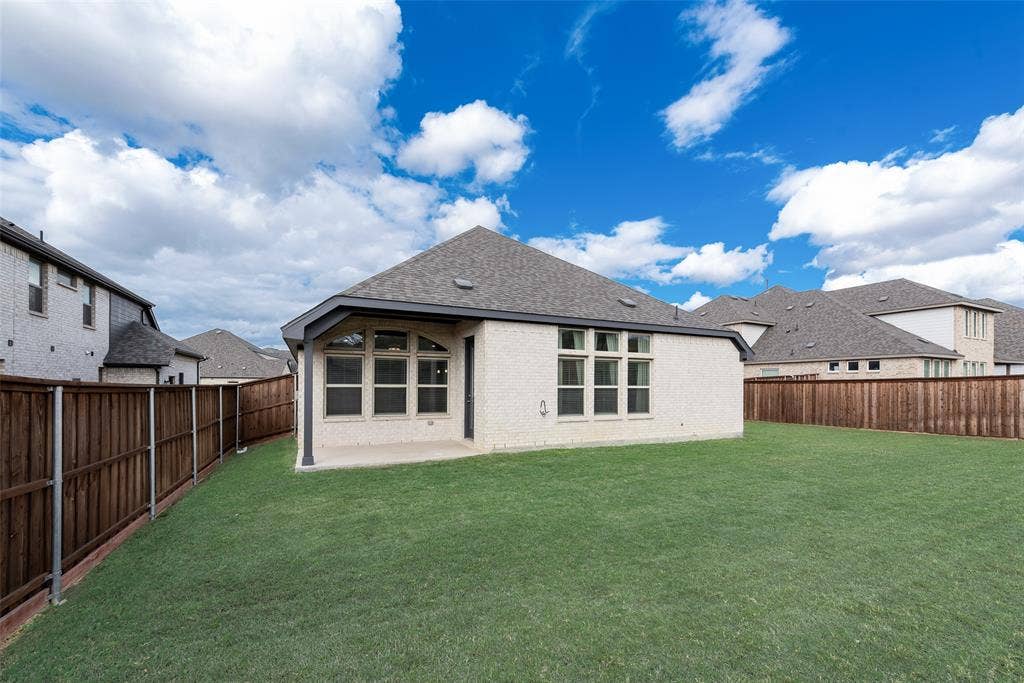 3934 Timberview Street, Midlothian, TX 76065 Backyard featuring a covered patio, expansive manicured lawn, and wood privacy fencing