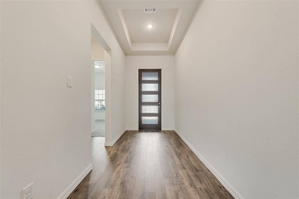 3934 Timberview Street, Midlothian, TX 76065 Entryway featuring wood-finish flooring, a tray ceiling, recessed lighting, and a front door with horizontal glass panels
