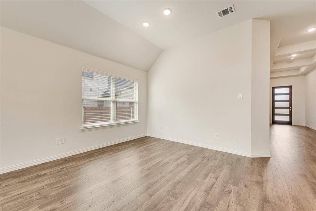 3934 Timberview Street, Midlothian, TX 76065 Interior space featuring vaulted ceilings, wood-finish flooring, recessed lighting, and a multi-panel exterior door with glass inserts