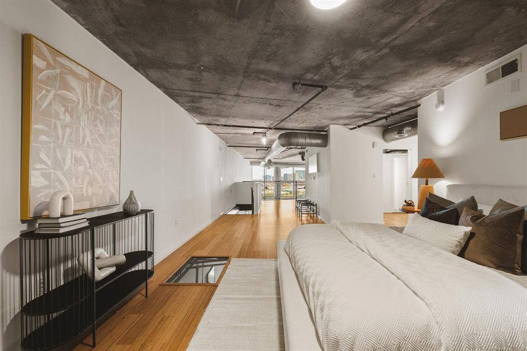 3110 Thomas Avenue, #717, Dallas, TX 75204 Exposed concrete ceiling with visible ductwork, wood-finish flooring, white walls, recessed lighting, and a glass floor panel
