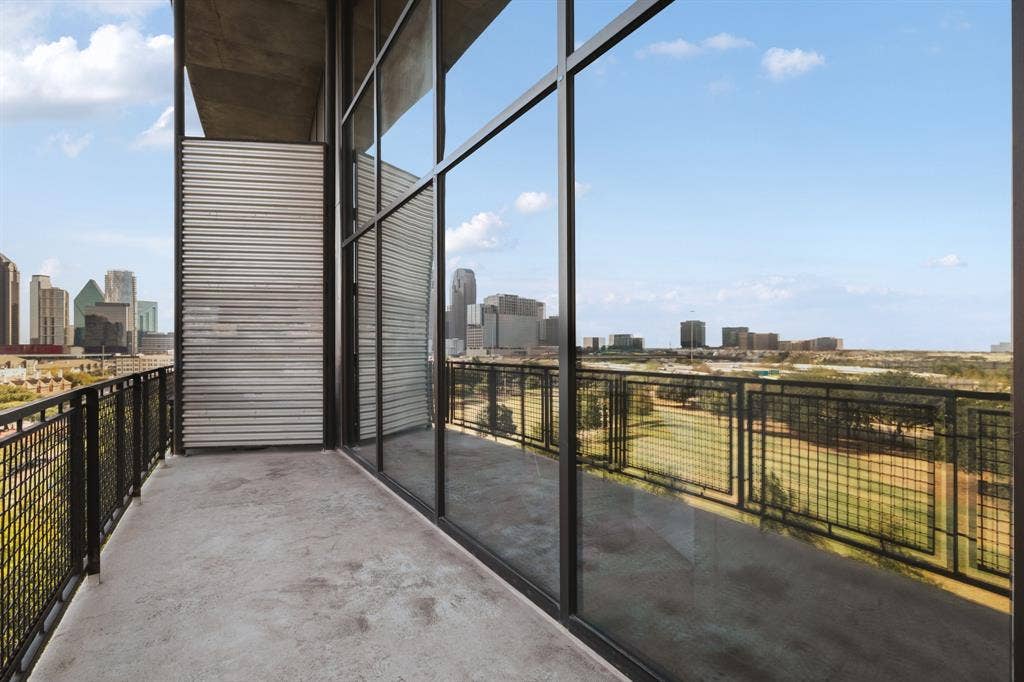 3110 Thomas Avenue, #717, Dallas, TX 75204 Expansive balcony with a concrete floor, black mesh railing, and floor-to-ceiling windows