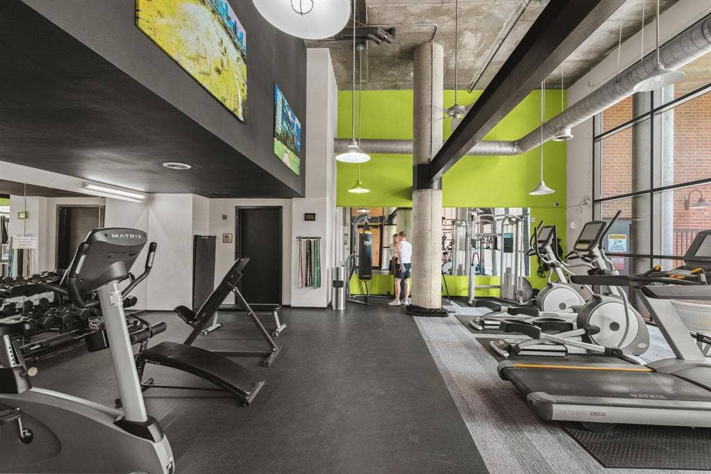 3110 Thomas Avenue, #717, Dallas, TX 75204 Fitness center with exposed ceiling, large windows, recessed and pendant lighting, and durable flooring