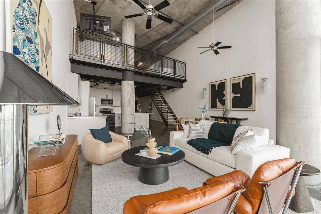 3110 Thomas Avenue, #717, Dallas, TX 75204 Vaulted ceiling, exposed concrete ceiling, industrial-style loft, mezzanine level, and open-concept living area