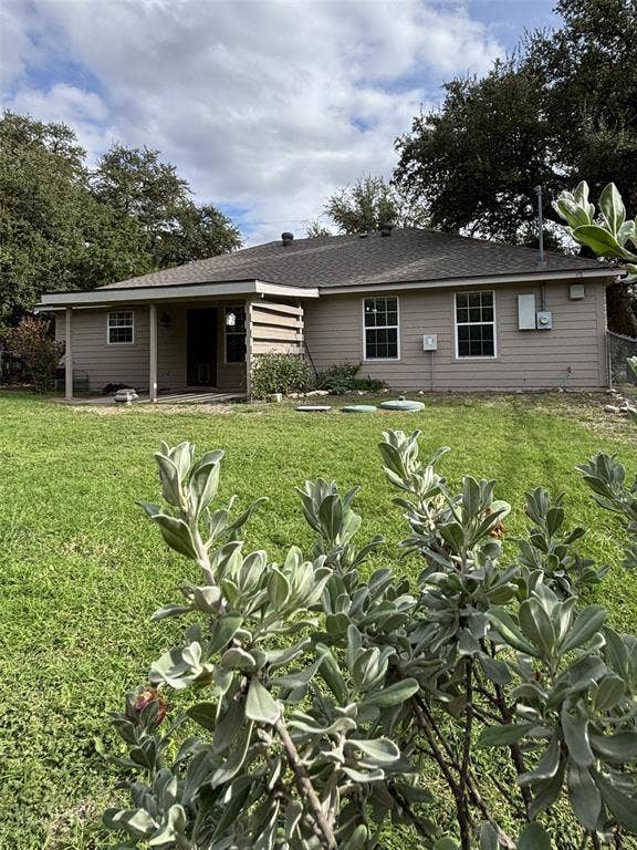 1 Mulberry Court, Morgans Point Resort, TX 76513 Rear exterior featuring horizontal lap siding, a covered patio, and a spacious grass yard with mature perimeter trees