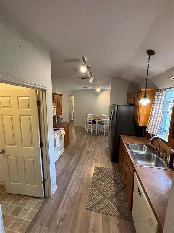 1 Mulberry Court, Morgans Point Resort, TX 76513 Kitchen featuring wood-finish flooring, wood cabinetry, dual-basin stainless steel sink with faucet, and overhead track lighting