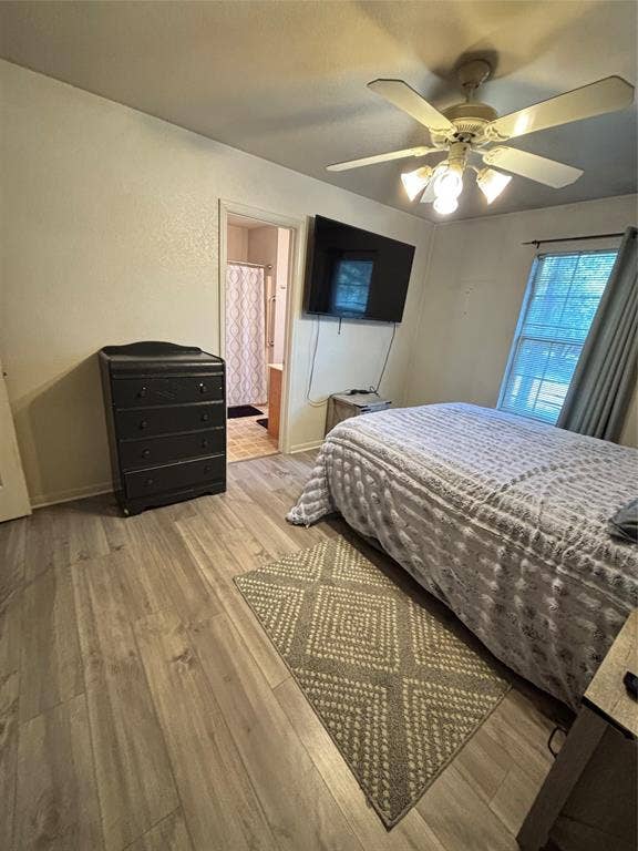 1 Mulberry Court, Morgans Point Resort, TX 76513 Primary bedroom featuring wood-finish flooring, a ceiling fan with integrated lighting, and a window with neutral drapery