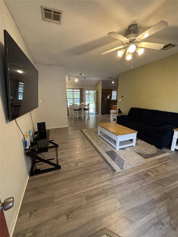 1 Mulberry Court, Morgans Point Resort, TX 76513 Open-concept interior featuring wood-finish flooring, a multi-blade ceiling fan with integrated lighting, and track lighting fixtures
