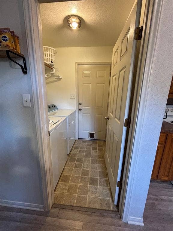 1 Mulberry Court, Morgans Point Resort, TX 76513 Utility space featuring tile flooring, built-in shelving, a dedicated laundry area, and an exterior door with an integrated pet portal