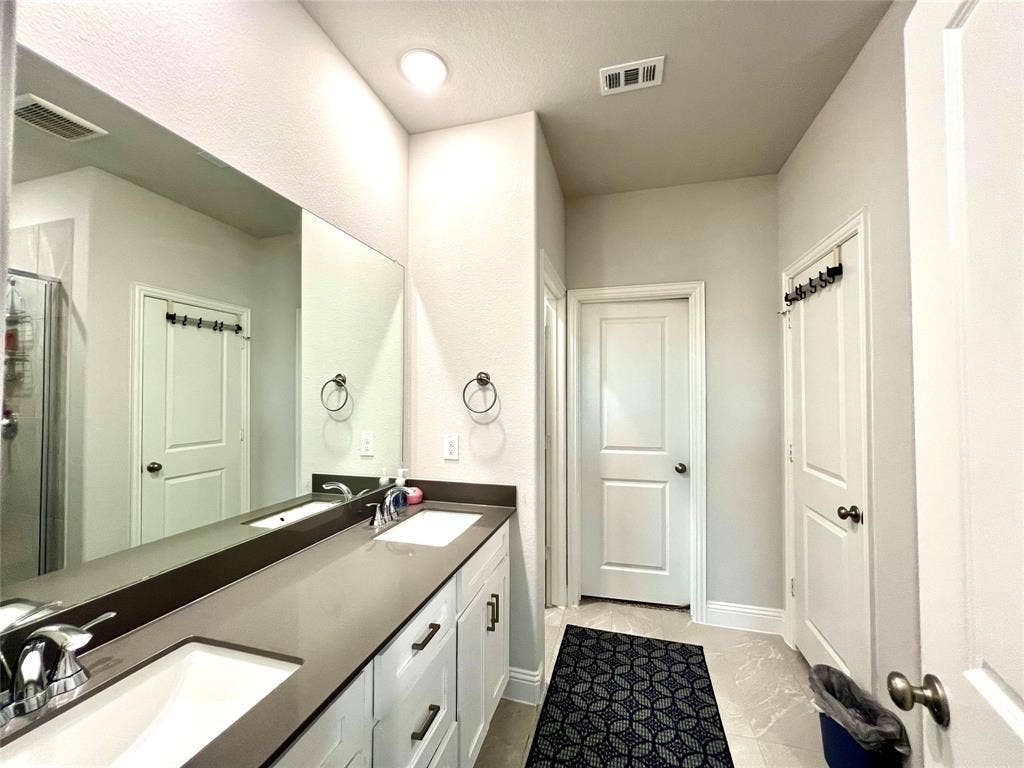 2707 Woodland Court, Wylie, TX 75098 Bathroom featuring vanity and a shower with shower door