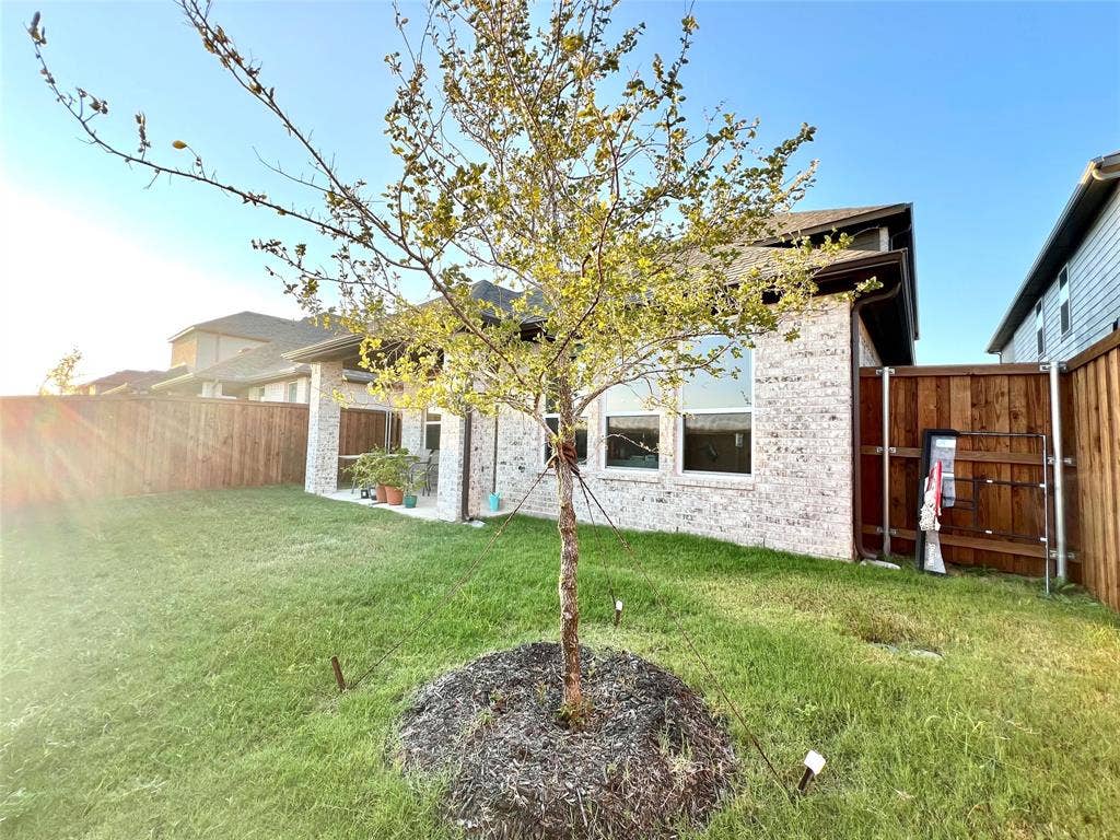 2707 Woodland Court, Wylie, TX 75098 Back of property featuring a yard