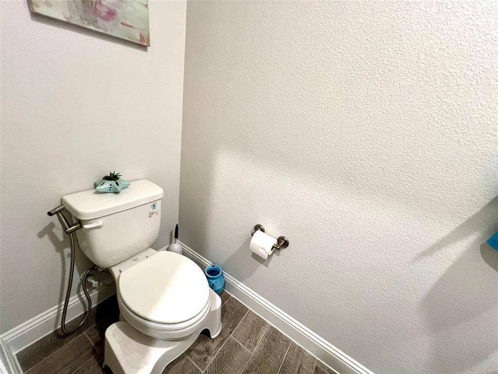 2707 Woodland Court, Wylie, TX 75098 Bathroom with toilet and hardwood / wood-style floors