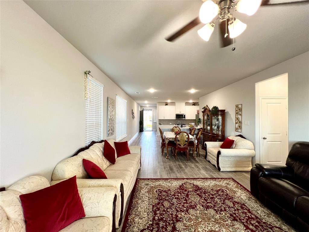 2707 Woodland Court, Wylie, TX 75098 Living room featuring ceiling fan and hardwood / wood-style flooring