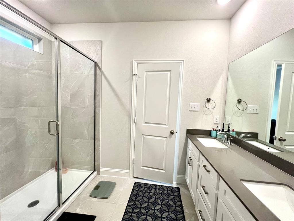2707 Woodland Court, Wylie, TX 75098 Bathroom featuring vanity, a shower with shower door, and tile patterned floors