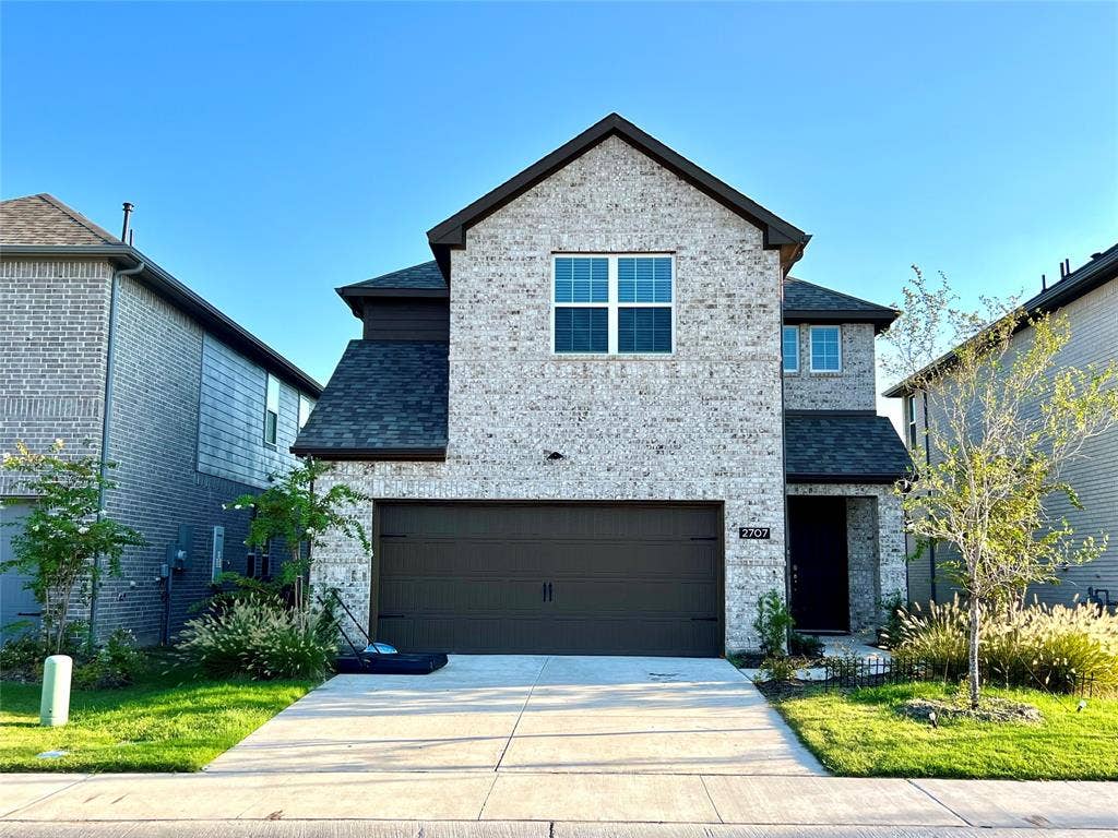 2707 Woodland Court, Wylie, TX 75098 View of front of property with a garage and a front lawn