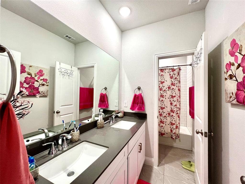 2707 Woodland Court, Wylie, TX 75098 Bathroom with vanity and shower / tub combo