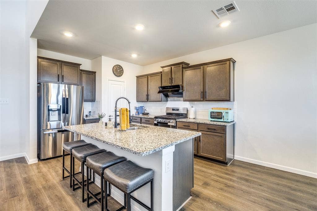 Open kitchen with an island and sitting. Non furnished but some furniture is negotiable or case by case.