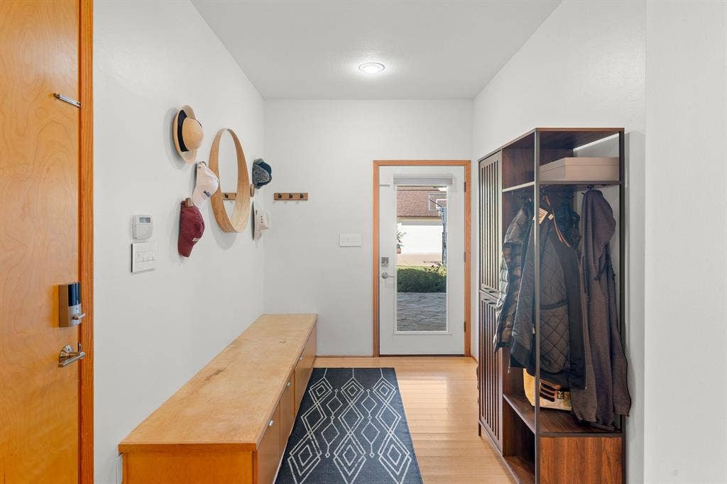 1997 Hollystone Drive, Tyler, TX 75703 Entryway featuring a wood-finish entry door with smart lock technology, built-in natural wood bench cabinetry, recessed lighting, and a glass-panel exterior door