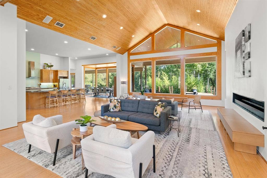 1997 Hollystone Drive, Tyler, TX 75703 Vaulted wood-plank ceiling, floor-to-ceiling windows with wood casing, linear gas fireplace with built-in bench, recessed lighting, and wood-finish flooring