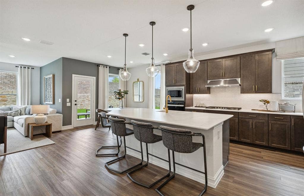 1437 Corleone Lane, Celina, TX 75009 *Model Representation - Large island gathering room and dining areas overlooking