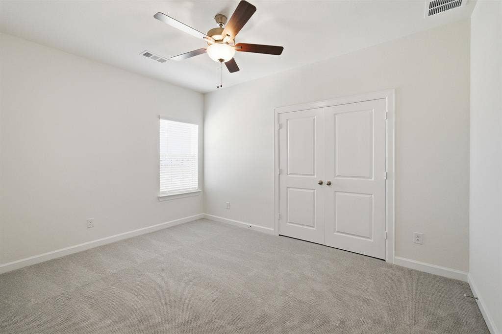 Neutral wall color complemented by light gray carpeting