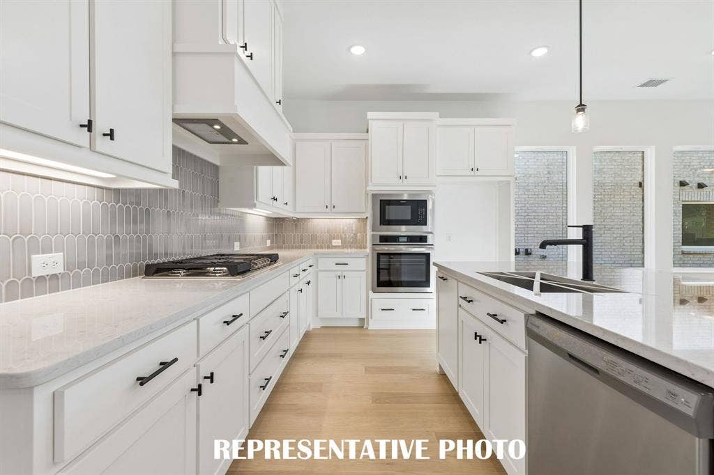 4553 Sunfish Lane, McKinney, TX 75071 Beautiful cabinetry, gorgeous countertops and designer backsplash effortlessly pair with contemporary stainless steel to create a kitchen for the ages! REPRESENTATIVE PHOTO