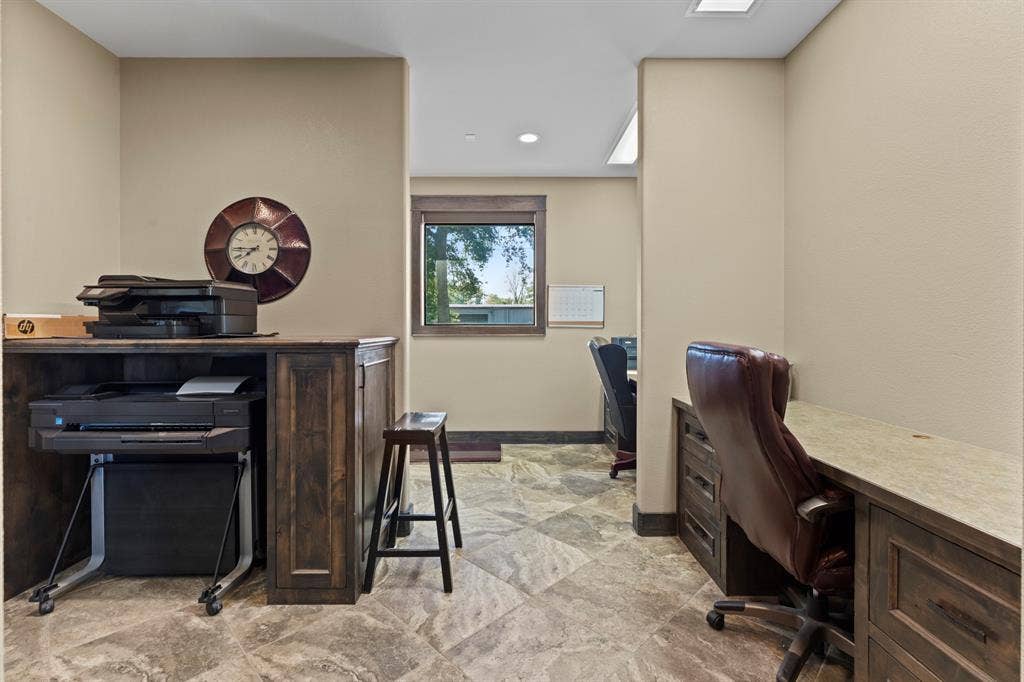 700 N Main Street, Lindale, TX 75771 Built-in wooden cabinetry, stone-finish tile flooring, and integrated desk workspace featuring countertop surface