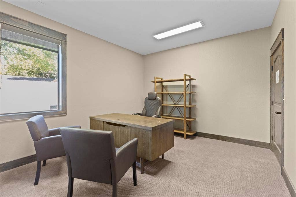 700 N Main Street, Lindale, TX 75771 Neutral-toned room featuring wall-to-wall carpeting, wood-finish window casing and door frame, and a rectangular ceiling-mounted light fixture
