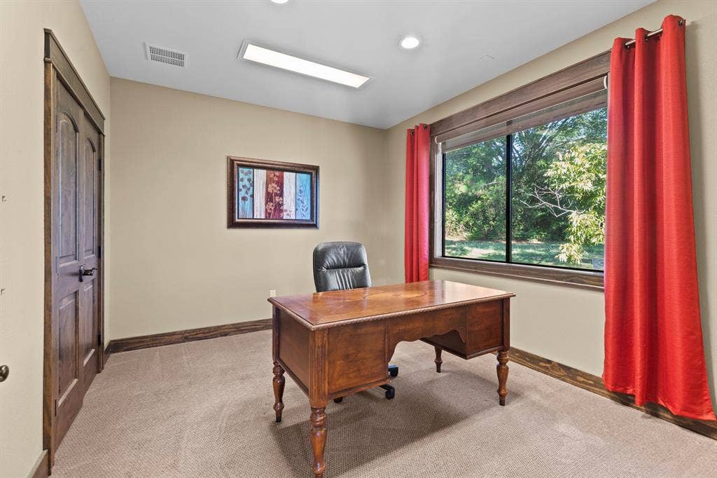 700 N Main Street, Lindale, TX 75771 Room featuring wood-trim accents, flush-mount lighting, and a window with exterior greenery