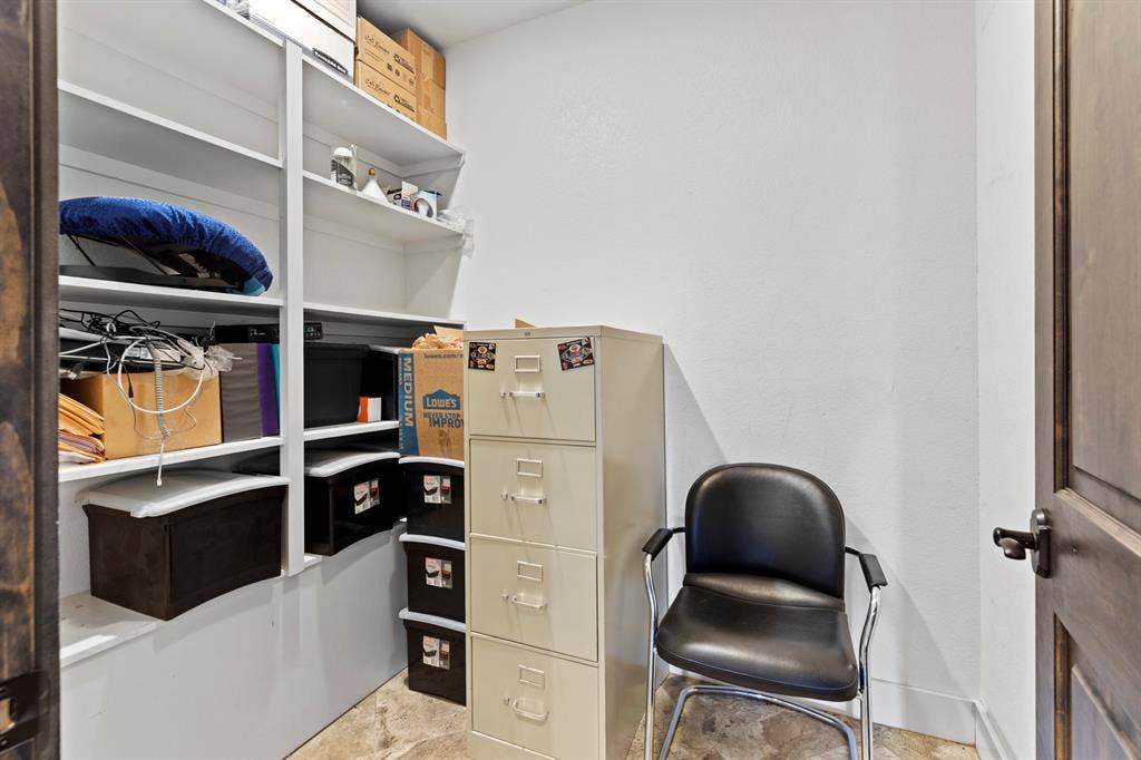 700 N Main Street, Lindale, TX 75771 Storage space featuring white built-in shelving units and stained wood-finish door with black hardware